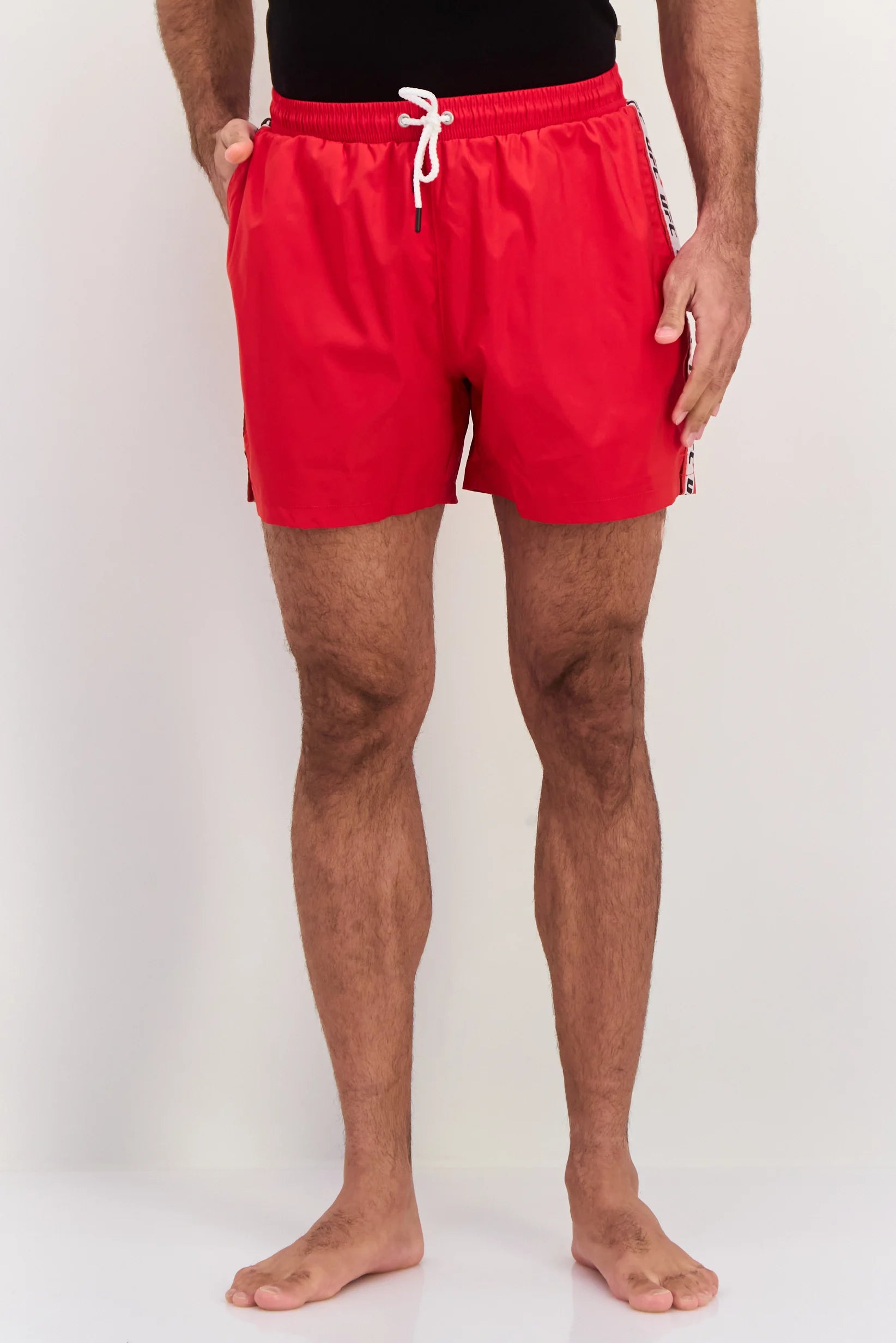 Person wearing red swim shorts