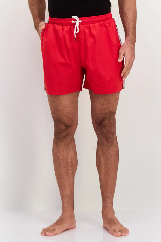Person wearing red swim shorts